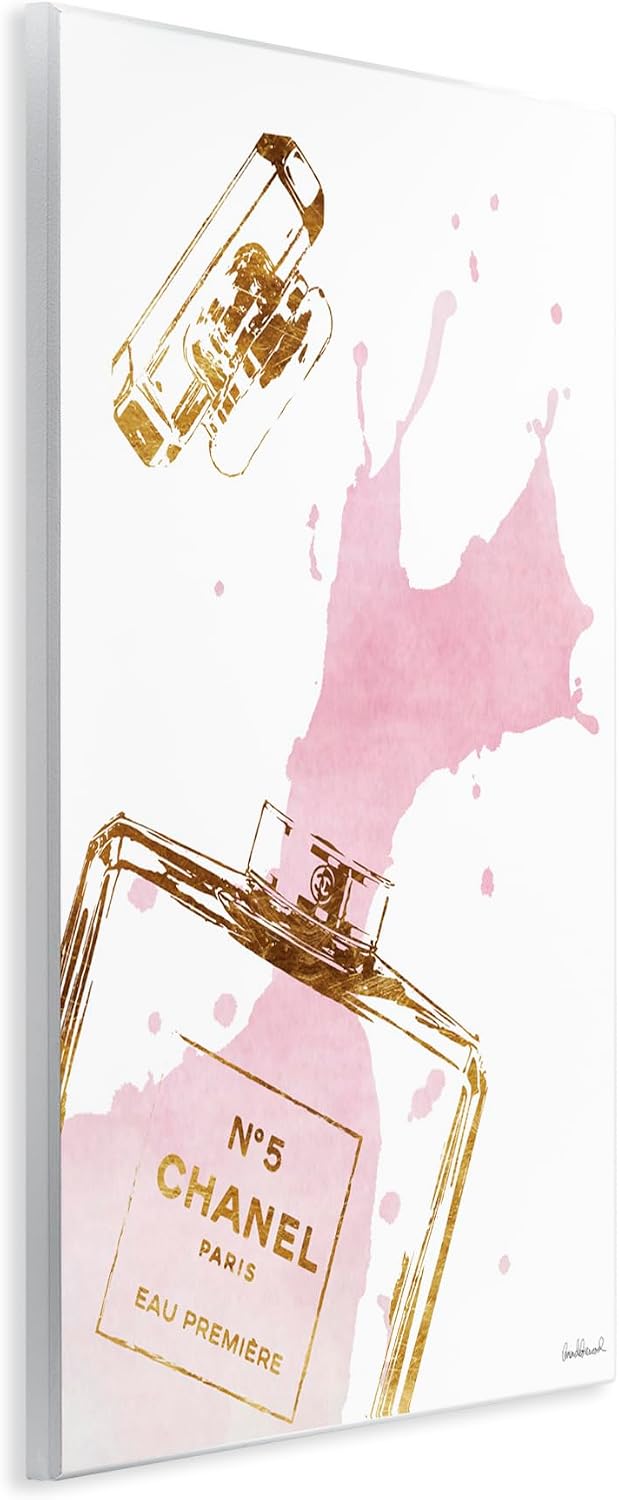 The Stupell Home Décor Collection Glam Perfume Bottle Splash Pink styled on a wall at home